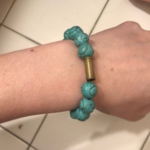 Turquoise band with gold shell casing